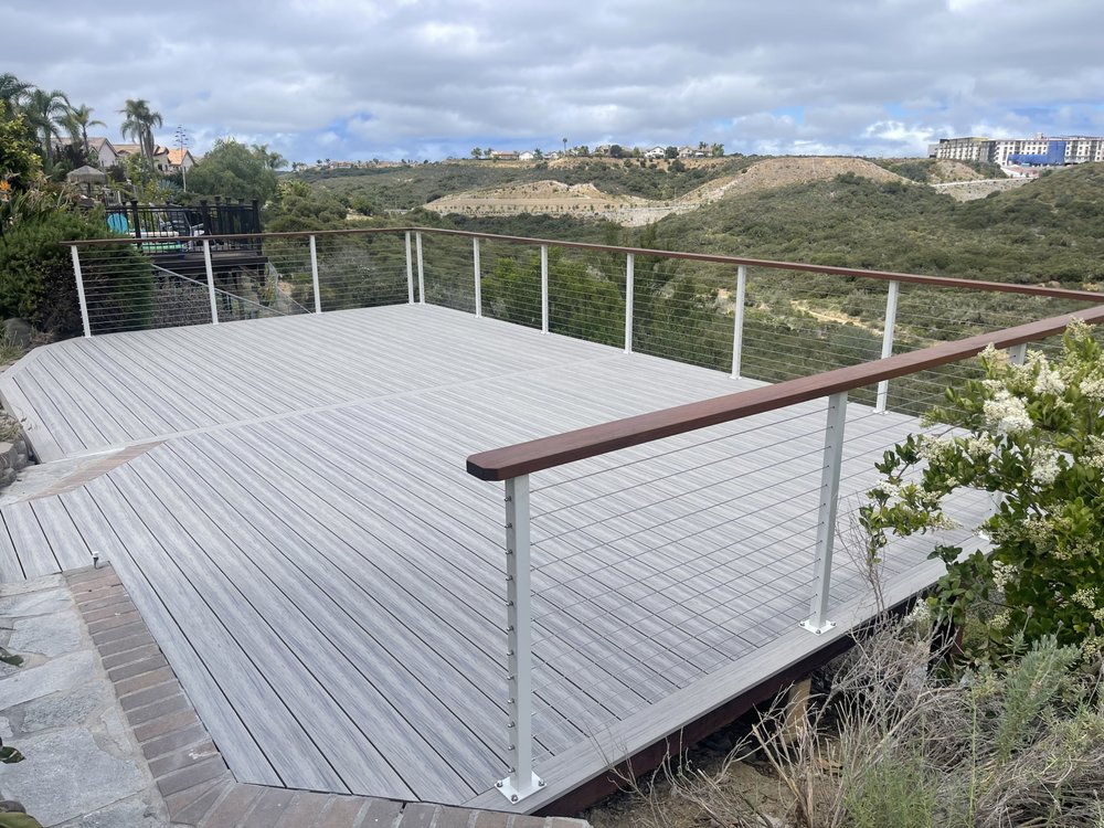 Grey composite deck with cable railing overlooking a San Diego canyon